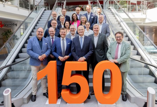 Group in front of "150" on stairs between escalators, sign "Venice" in the background.