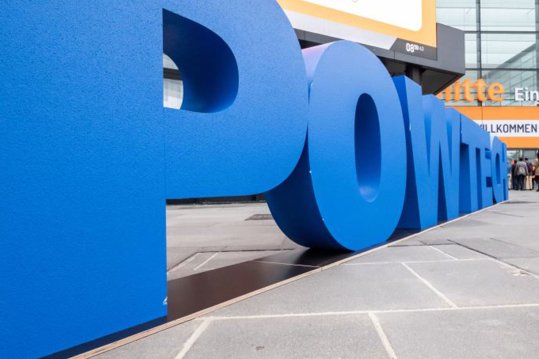 Large letters in front of the entrance center make the word POWTECH